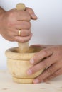 Chef crushing garlic and parsley with mortar and pestle in the k Royalty Free Stock Photo