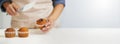 Chef, cupcakes and person icing muffin with mockup or copy space isolated against a white background. Closeup, hands and