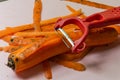 The chef cuts a carrot with a knife