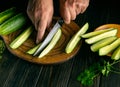 The chef cuts cucumbers into lengthwise slices for serving before dinner. Cucumber diet concept Royalty Free Stock Photo