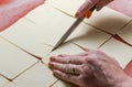 The chef cuts the dough with a knife