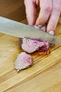 Chef cuts grilled meat on the board with a full series of blood recipe cooking Royalty Free Stock Photo