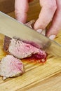 Chef cuts grilled meat on the board with a full series of blood recipe cooking Royalty Free Stock Photo