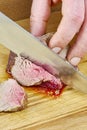 Chef cuts grilled meat on the board with a full series of blood recipe cooking Royalty Free Stock Photo