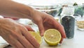 Chef cuts lemon in half. Salad dressing recipe