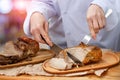 Chef cuts the meat is cooked . Royalty Free Stock Photo