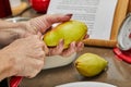 Chef cuts the pears into slices for chocolate cake with pear and nuts. Step by step recipe Royalty Free Stock Photo