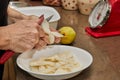 Chef cuts the pears into slices for chocolate cake with pear and nuts. Step by step recipe Royalty Free Stock Photo