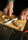 The chef cuts pork sausage on a cutting kitchen board for a delicious lunch. The national dish is sometimes cooked at home Royalty Free Stock Photo