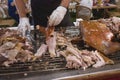 Chef cuts up baked pig pork to serve to guests at buffet Royalty Free Stock Photo