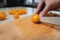 The chef cuts vegetables into a salad on a wooden cutting board in the kitchen at home. Cooking. The woman uses a knife Royalty Free Stock Photo