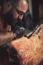 Chef cutting beef carcass in a restaurant Royalty Free Stock Photo