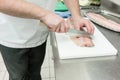 Chef cutting carp fish fillet