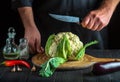 The chef cutting cauliflower in a restaurant kitchen. The idea of a delicious diet for breakfast or dinner Royalty Free Stock Photo
