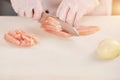 Chef cutting chicken fillet on board. Royalty Free Stock Photo