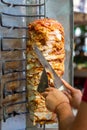 Chef cutting with doner knife Traditional Turkish Doner Kebab meat