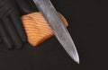 Close up of chef slicing salmon with sharp knife Royalty Free Stock Photo