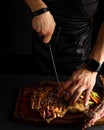 Chef cutting grilled T-bone steak before serving Royalty Free Stock Photo