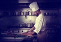 Chef cutting meat in restaurant kitchen Royalty Free Stock Photo