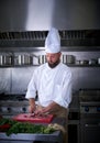 Chef cutting meat in restaurant kitchen Royalty Free Stock Photo