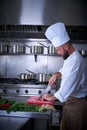 Chef cutting meat in restaurant kitchen Royalty Free Stock Photo