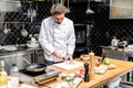 chef cutting mushroom