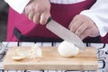 Chef cutting onion with knife Royalty Free Stock Photo