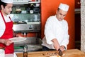 Chef cutting pizza into pieces Royalty Free Stock Photo