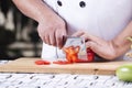 Chef cutting red bell pepper Royalty Free Stock Photo