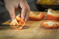 Chef cutting red bell pepper on wooden broad Royalty Free Stock Photo