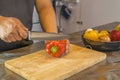 Chef cutting red bell pepper on wooden broad Royalty Free Stock Photo