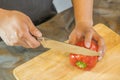 Chef cutting red bell pepper on wooden broad Royalty Free Stock Photo