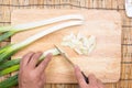 Chef cutting scallion on wooden broad Royalty Free Stock Photo