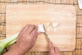 Chef cutting scallion on wooden broad Royalty Free Stock Photo