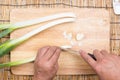 Chef cutting scallion on wooden broad Royalty Free Stock Photo