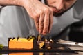 Chef decorate dessert at kitchen. Closeup hand decorate cake with chocolate. Royalty Free Stock Photo