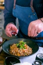 Chef decorates the buckwheat noodles with duck and mushroom. Master class in the kitchen. The process of cooking. Step by step.