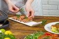 Chef decorating sliced fried tuna fish with vegetables