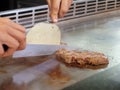 Chef Deliberately Preparing and Cooking Traditional Teppanyaki on Hot Plate