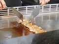 Chef Deliberately Preparing and Cooking Traditional Teppanyaki on Hot Plate