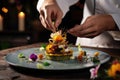 Chef delicately garnishes a complexly arranged dish, creating a culinary work of art