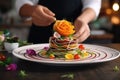 Chef delicately garnishes a complexly arranged dish, creating a culinary work of art