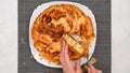 Chef delicately slices through a freshly baked phyllo dough pie