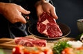 Chef displaying a tender fresh raw beef steak