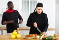 Chef dissatisfied with prepared dish of female cook Royalty Free Stock Photo