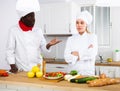 Chef dissatisfied with prepared dish of female cook Royalty Free Stock Photo