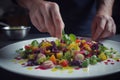 Chef finishing her plate and almost ready to serve at the table. Royalty Free Stock Photo