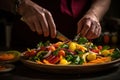 Chef finishing her plate and almost ready to serve at the table. Royalty Free Stock Photo