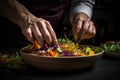 Chef finishing her plate and almost ready to serve at the table. Royalty Free Stock Photo