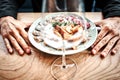 Chef finishing her plate and almost ready to serve at the table. Only hands. Finally dish dressing: steak meat, fish Royalty Free Stock Photo